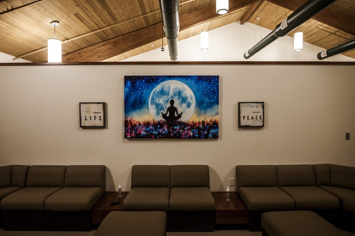 Quiet lounge with sectional seating and meditation artwork