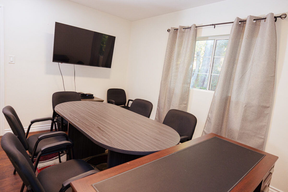 Group therapy room with conference table and seating