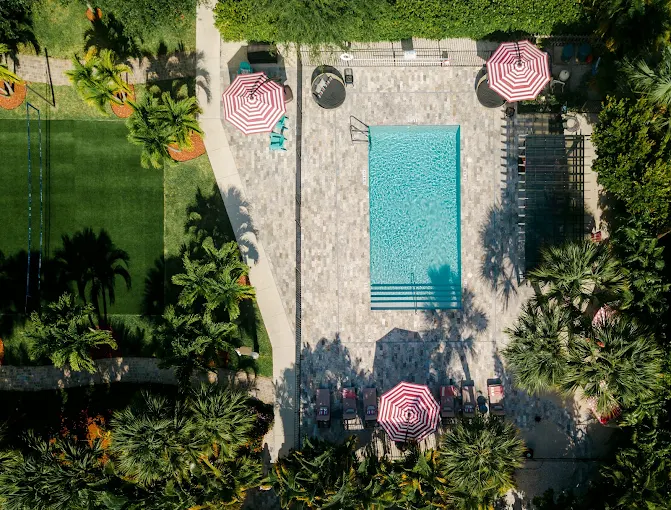 Aerial view of pool with lounge chairs and umbrellas