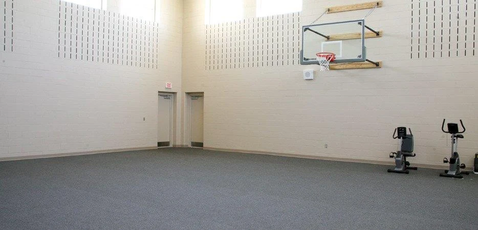 Indoor gym with basketball hoop and fitness bikes