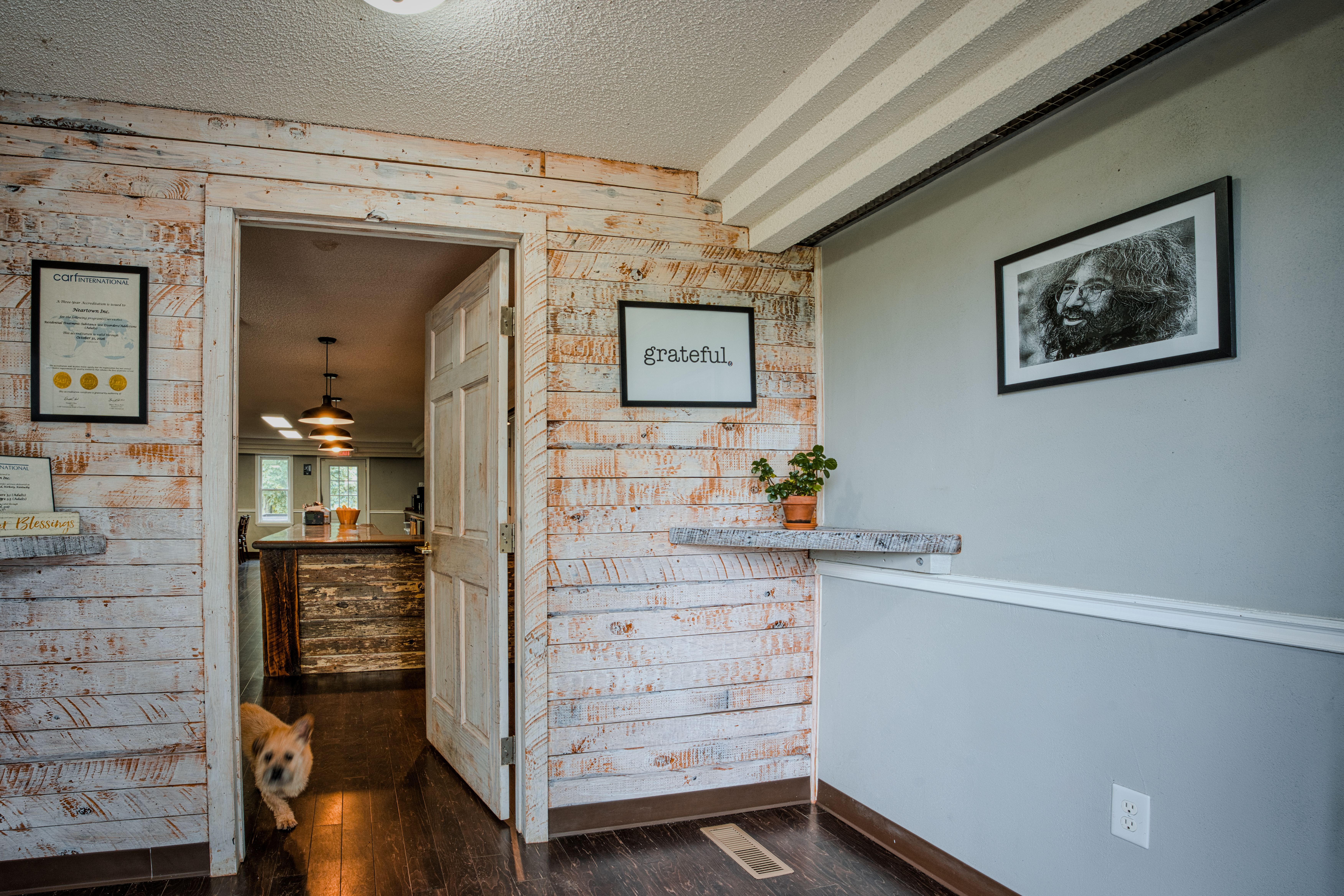 Warm, rustic entryway displaying the CARF accreditation seal