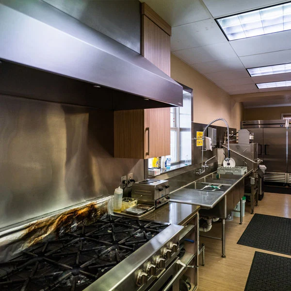 Commercial kitchen with stainless steel appliances and prep space