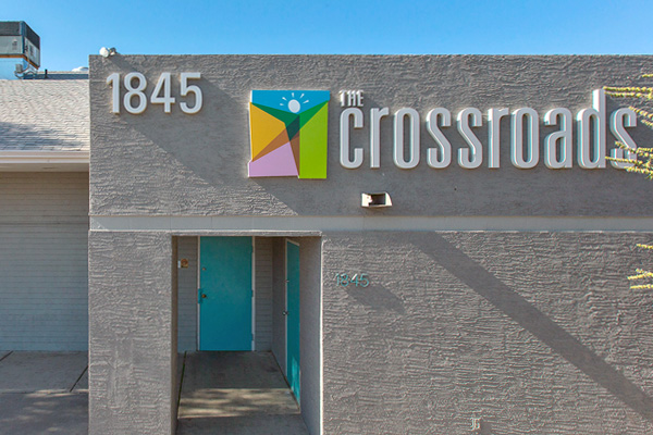Crossroads East entrance with logo, number 1845, and turquoise door.