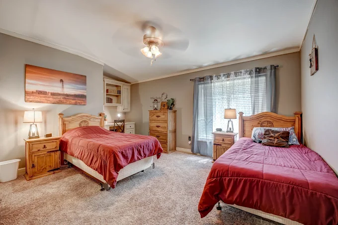 Shared bedroom with two beds and natural light