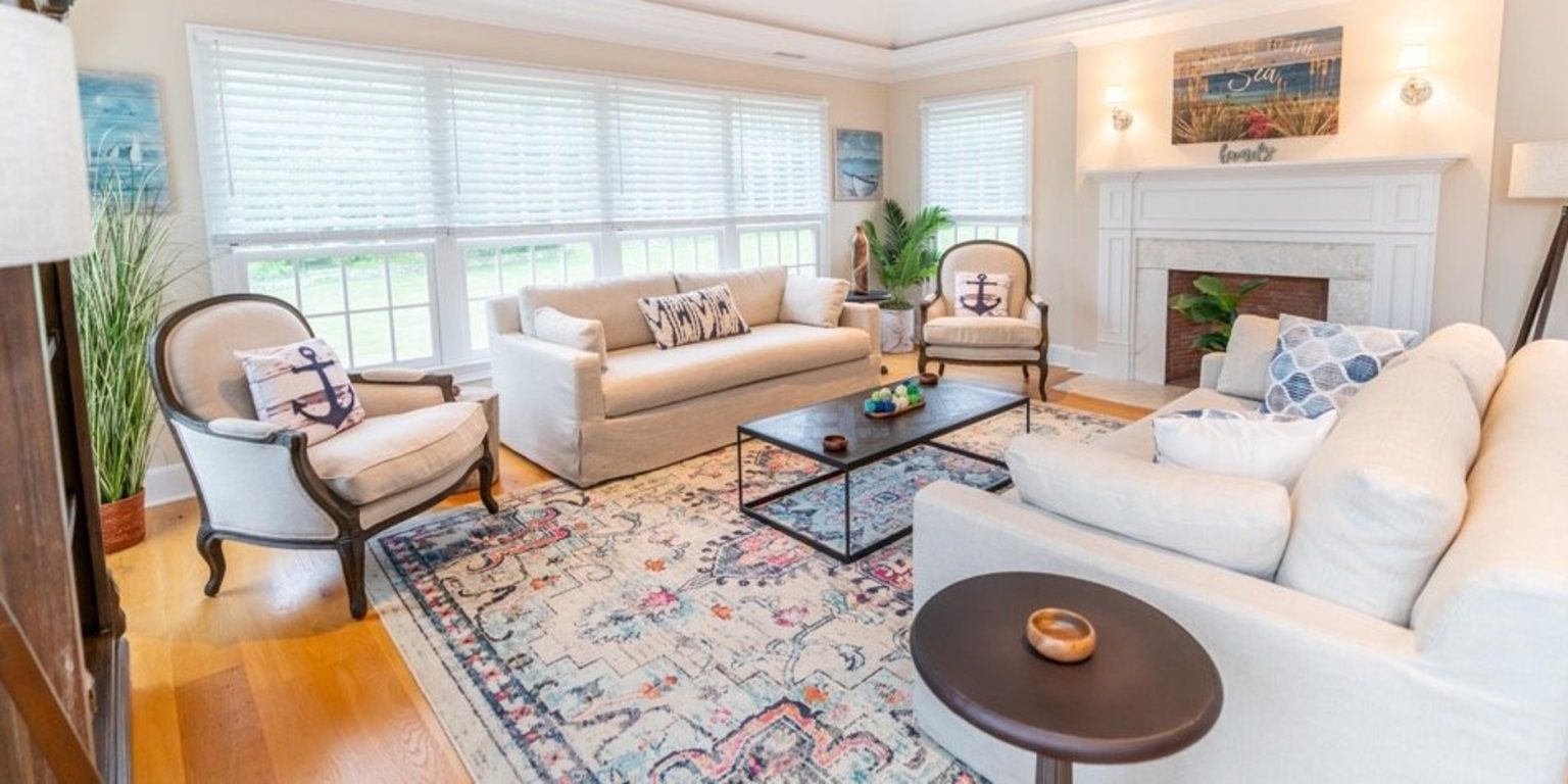 Cozy living room with sofas, armchairs, and fireplace