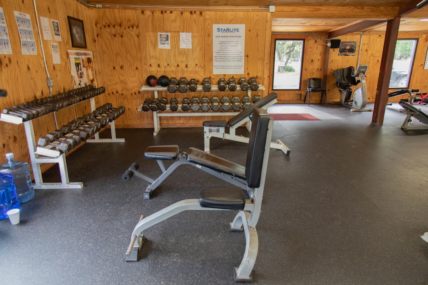 Fitness room with dumbbells, benches, and cardio equipment