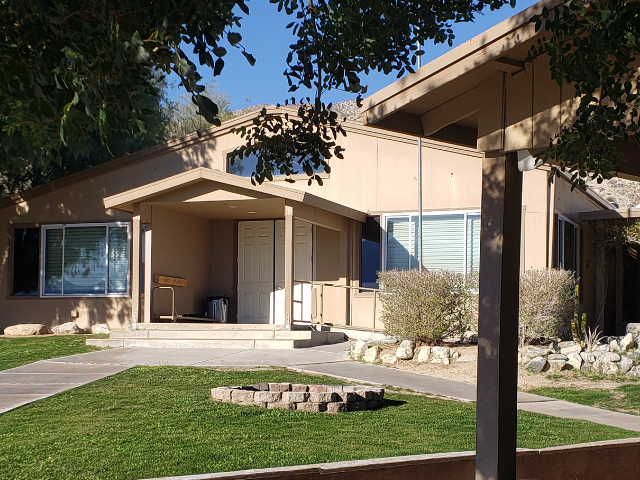 Single-story residential buildings with walkways and landscaped grounds