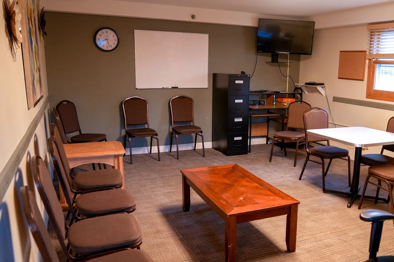 Group therapy room with chairs and whiteboard
