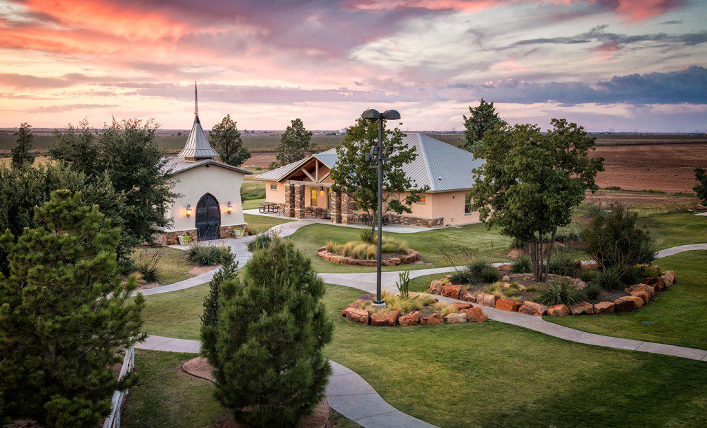 Campus grounds with walking paths and landscaped gardens