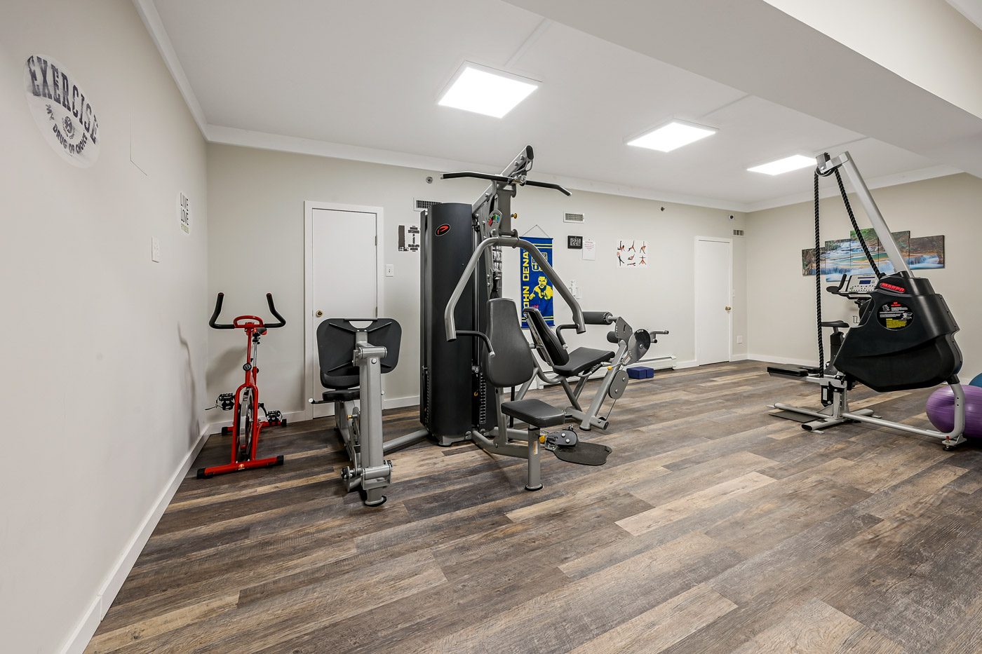 Fitness room with exercise machines and bright lighting