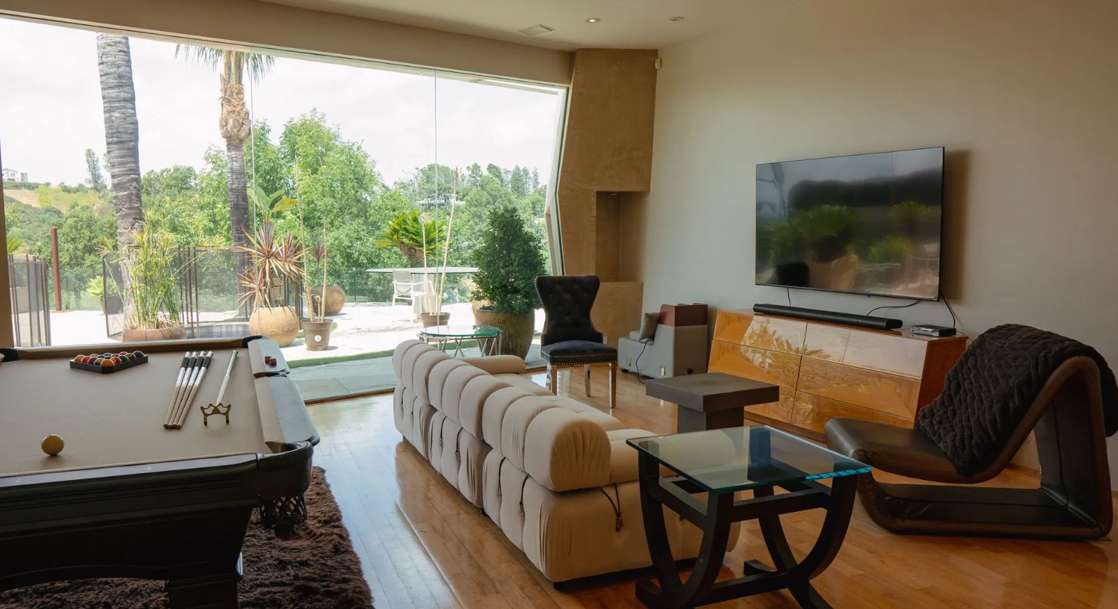 Lounge with large TV, pool table, and outdoor views