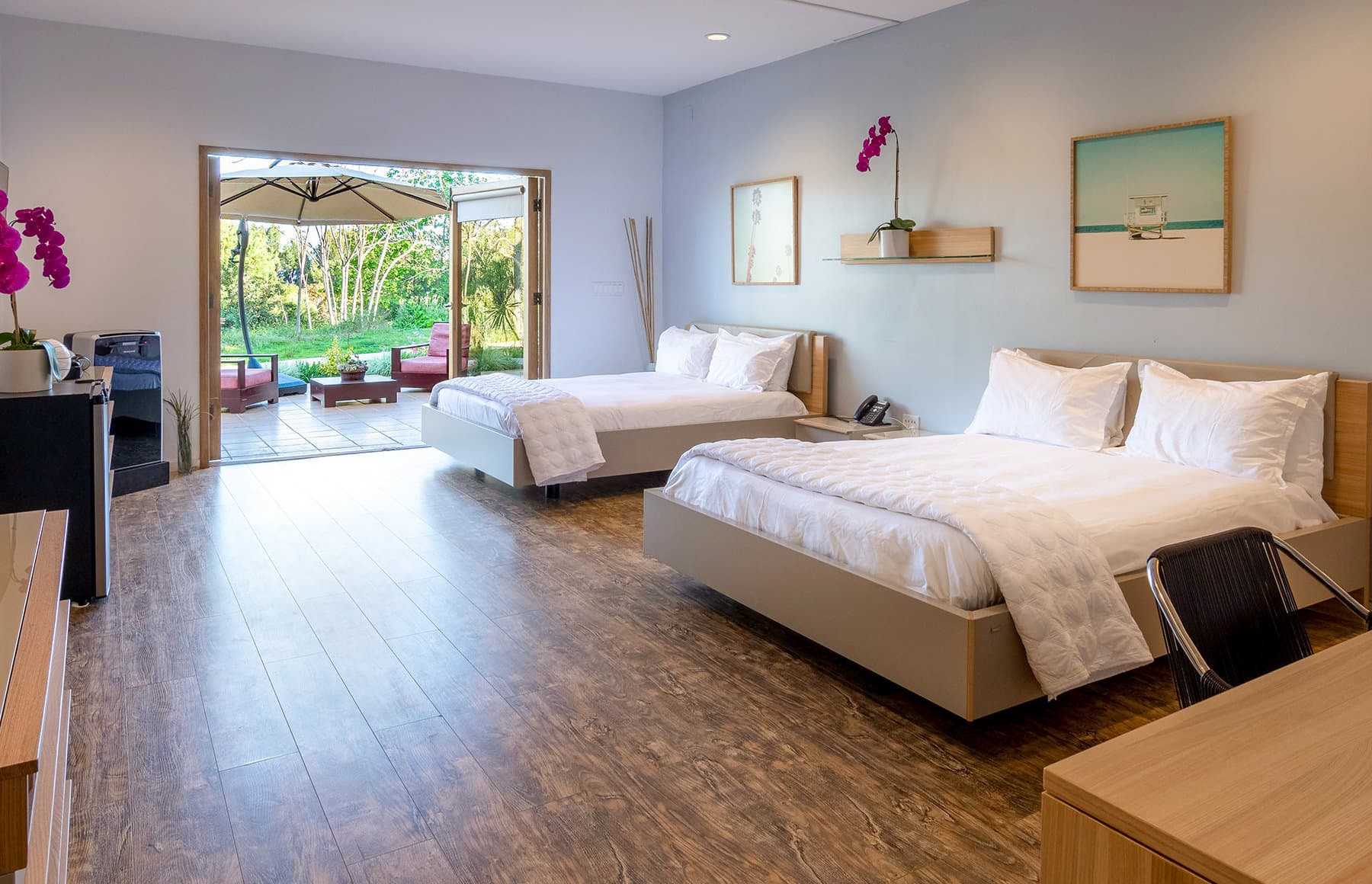 Shared bedroom with two beds and private patio seating