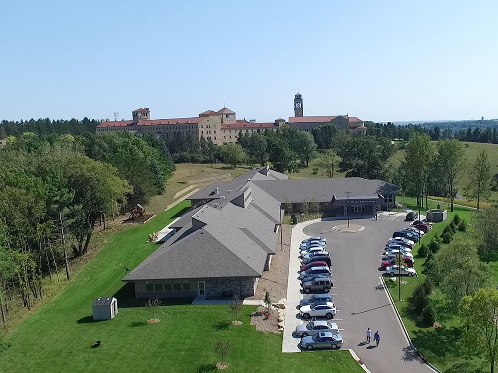 Aerial view of rehab campus with parking lot and surrounding trees