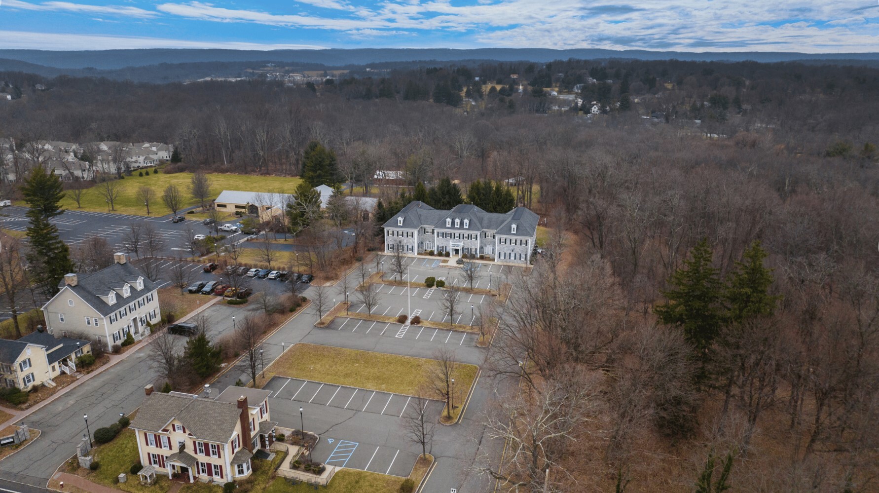 Aerial view of rehab facility showing building and parking.