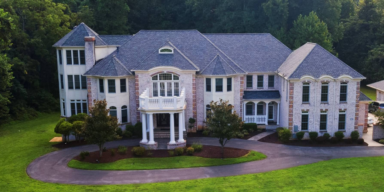 Large residential treatment facility surrounded by trees and landscaped grounds