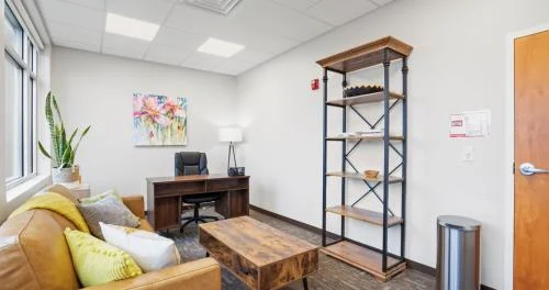 Private counseling room with sofa and desk
