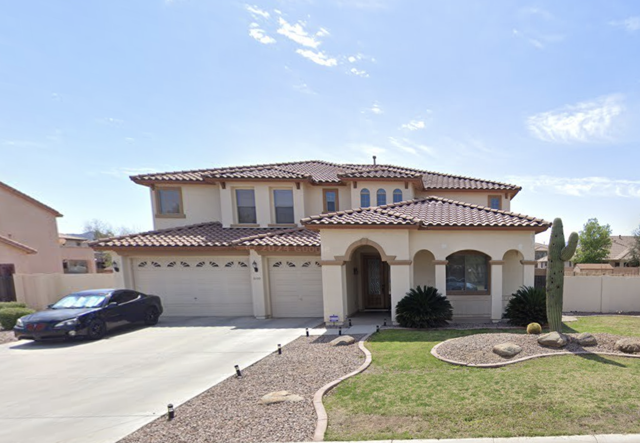 Large two-story recovery home with driveway and desert landscaping