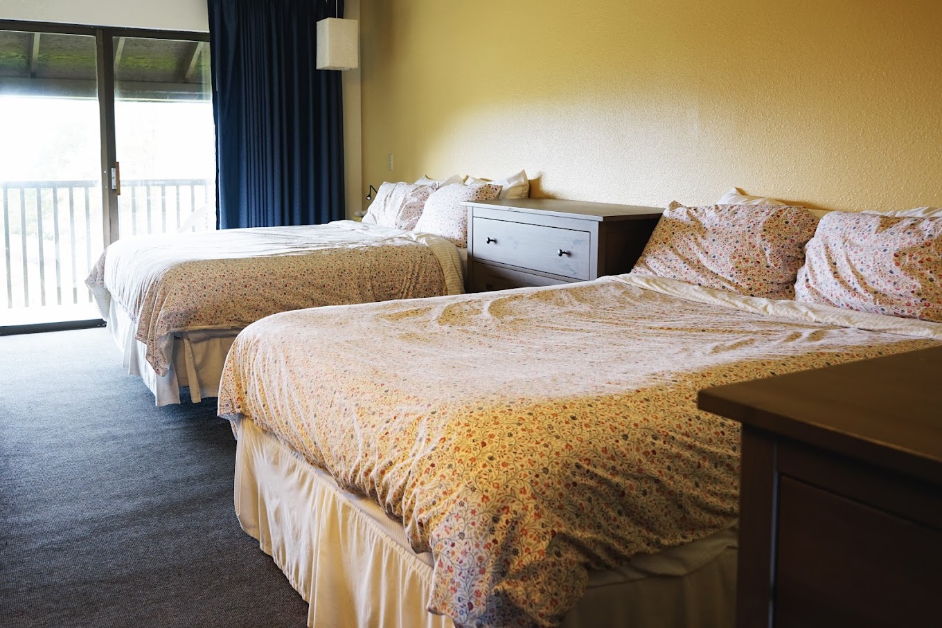 A cozy rehab bedroom with two beds and a sliding door.