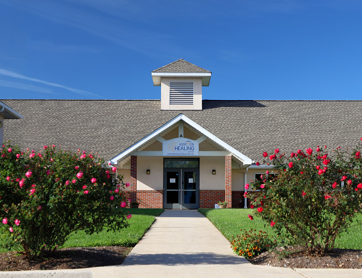 Addiction Healing Center entrance with flowers along the walkway.