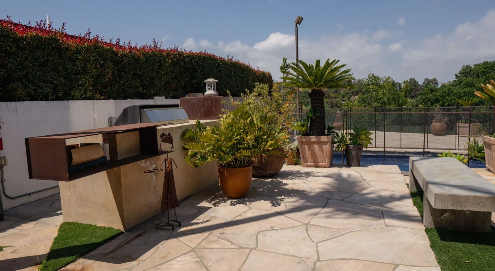 Outdoor BBQ patio with seating and landscaped grounds