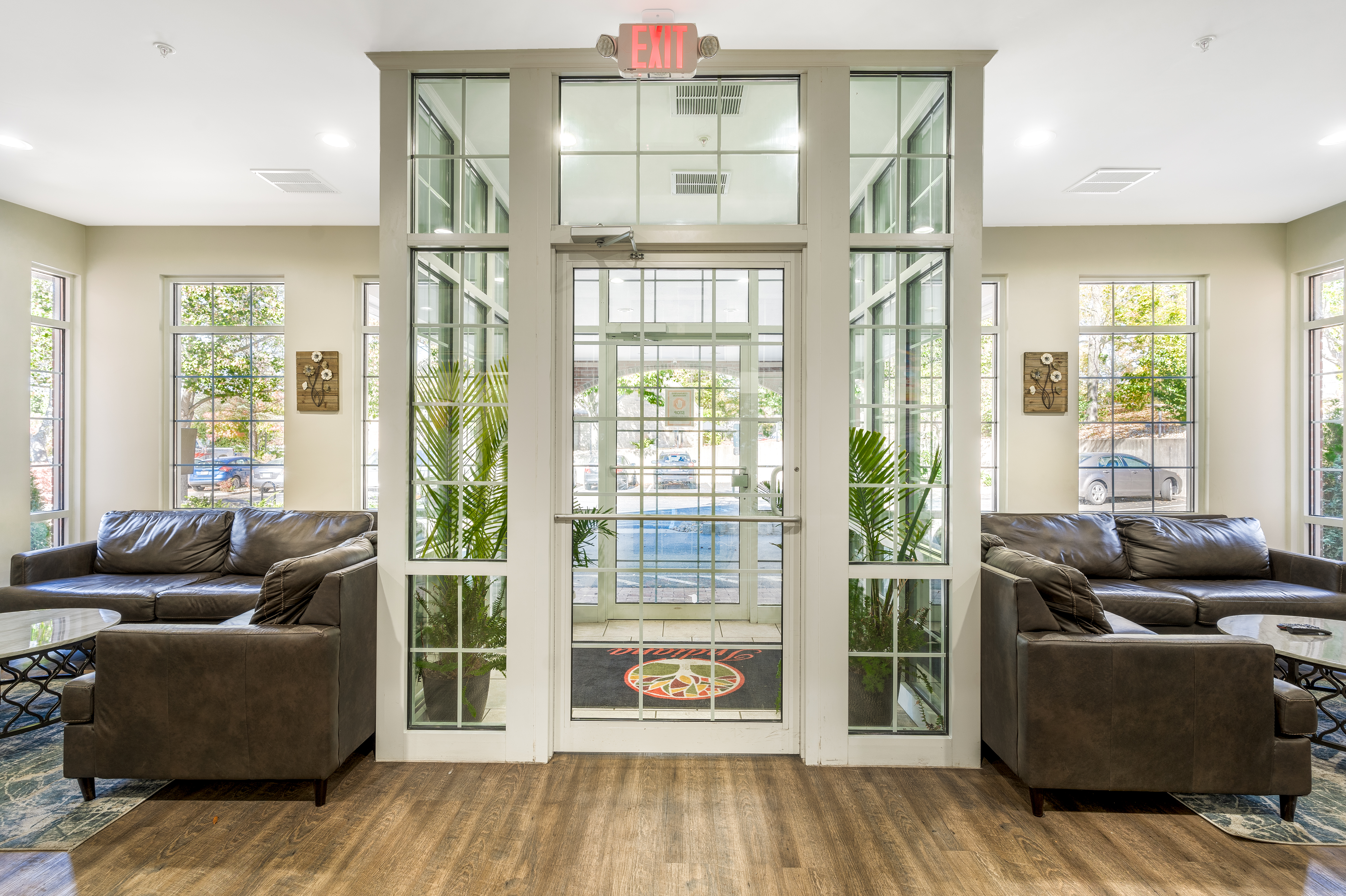 Bright lobby with leather seating and large windows.