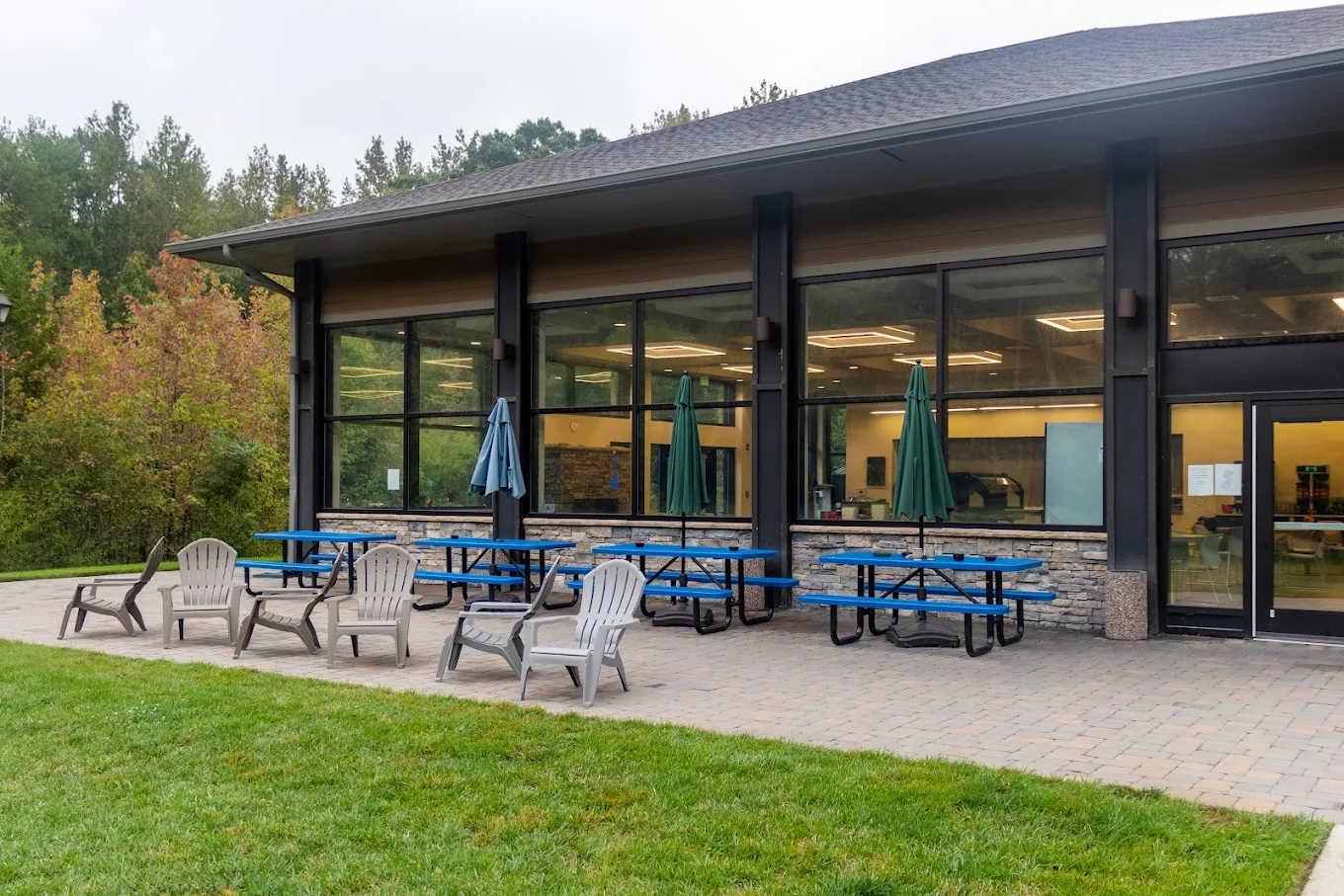 Covered patio with picnic tables overlooking grassy lawn