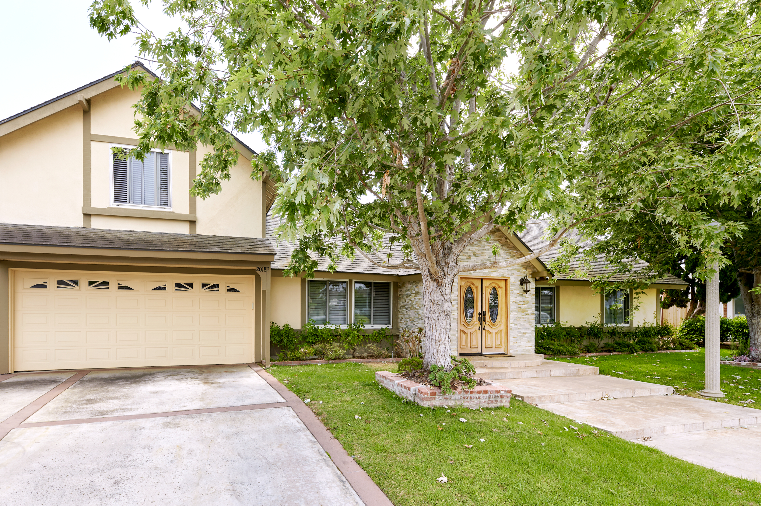 Facility driveway with double garage, and entrance.