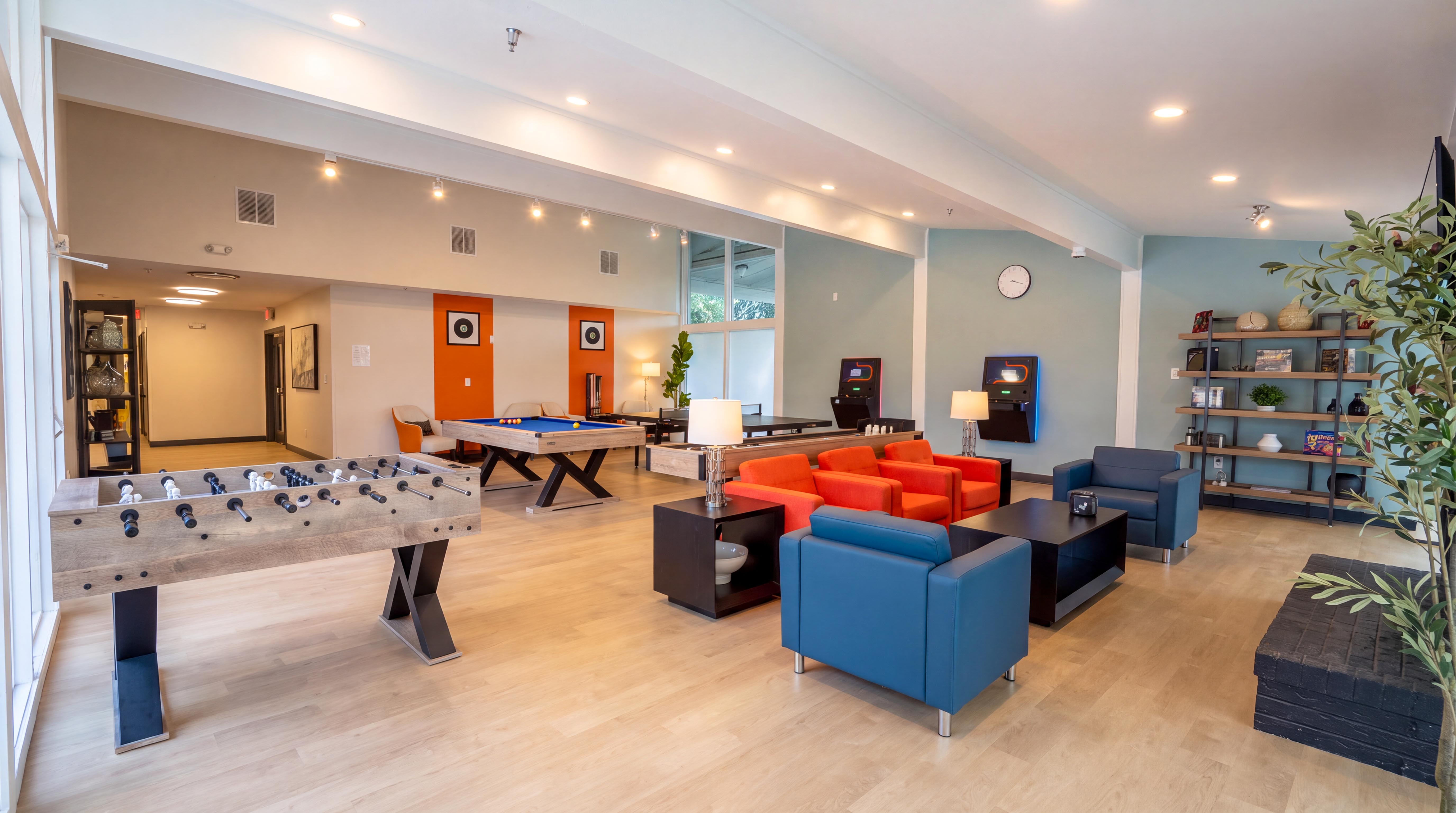 Recreation room with foosball table and colorful seating
