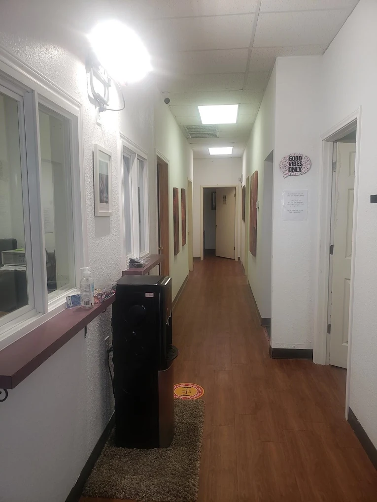 Hallway inside clinic with wall signs and lights