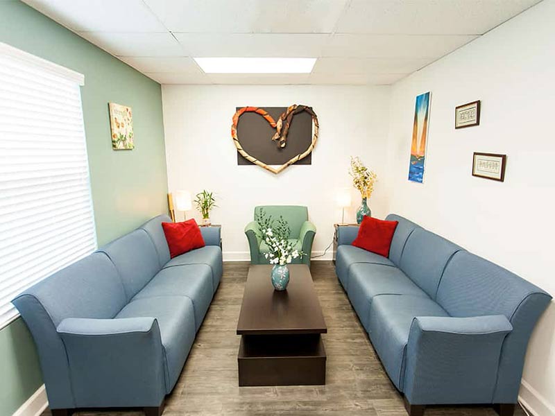 Cozy lounge with sofas, chair, and wall art