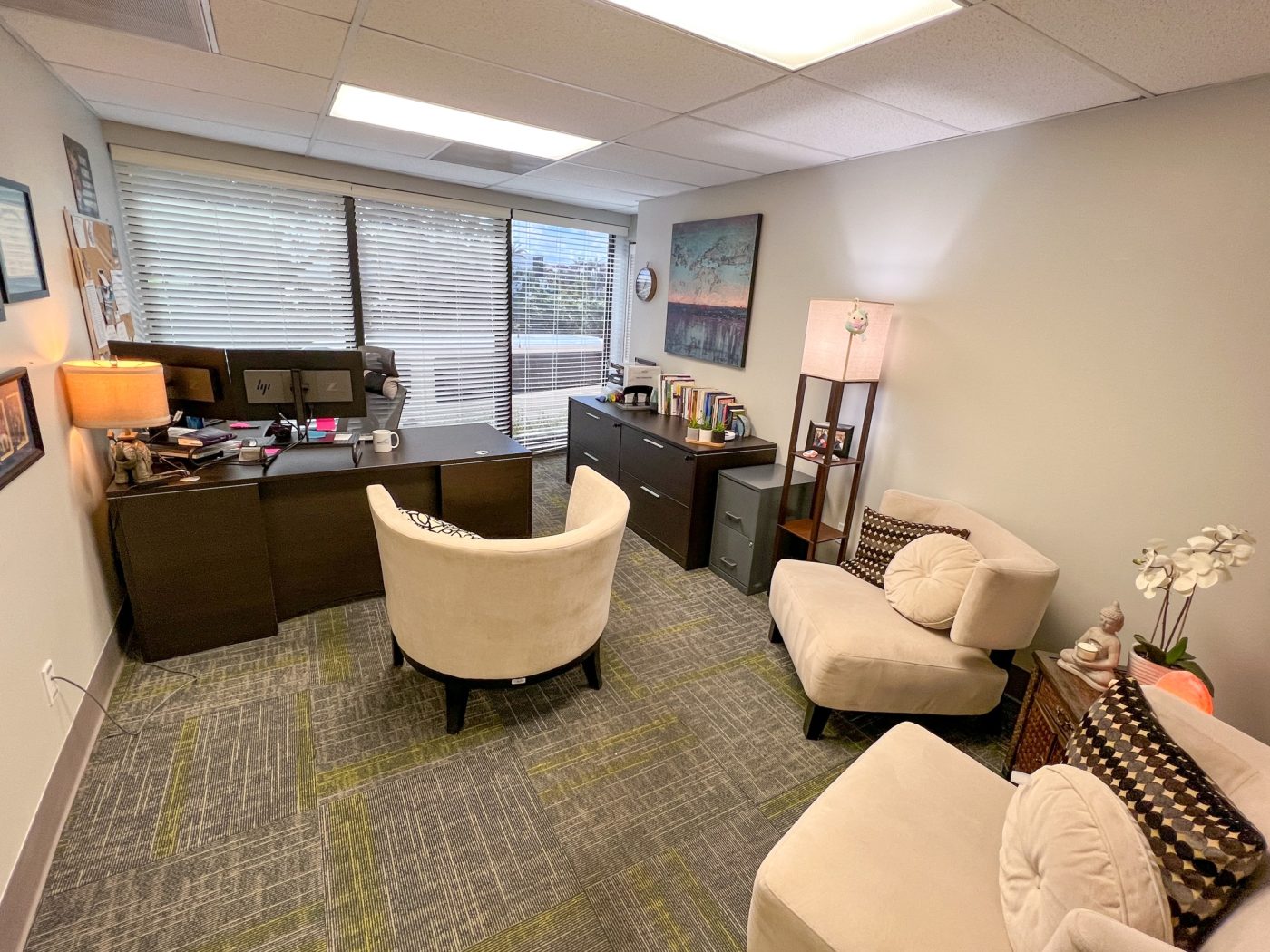Private counseling office with seating and desk for therapy sessions