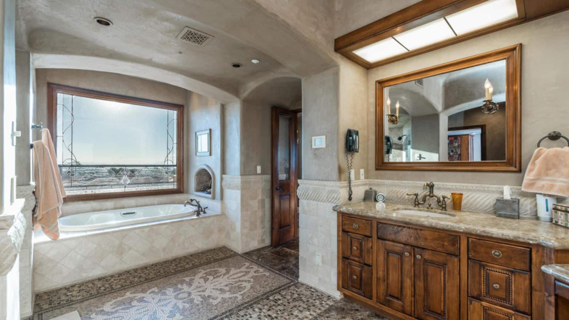 Elegant bathroom with tub and desert view