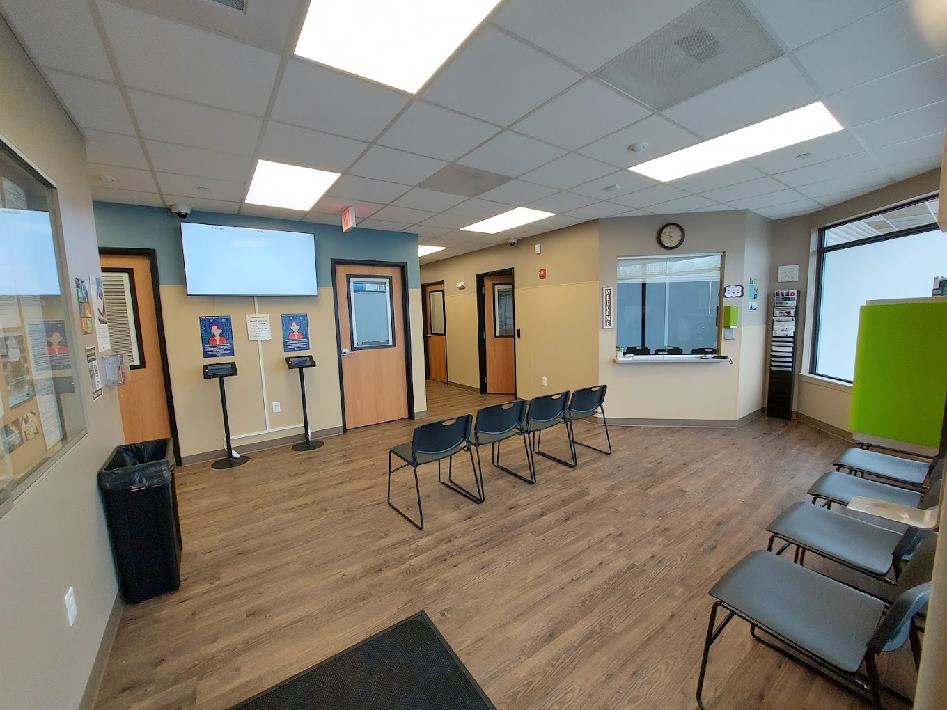 Waiting area with reception window and seating.