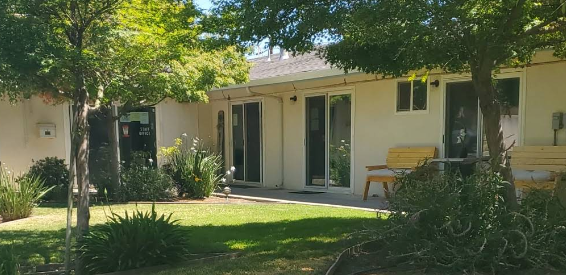 Front courtyard with trees and seating at New Hope Recovery