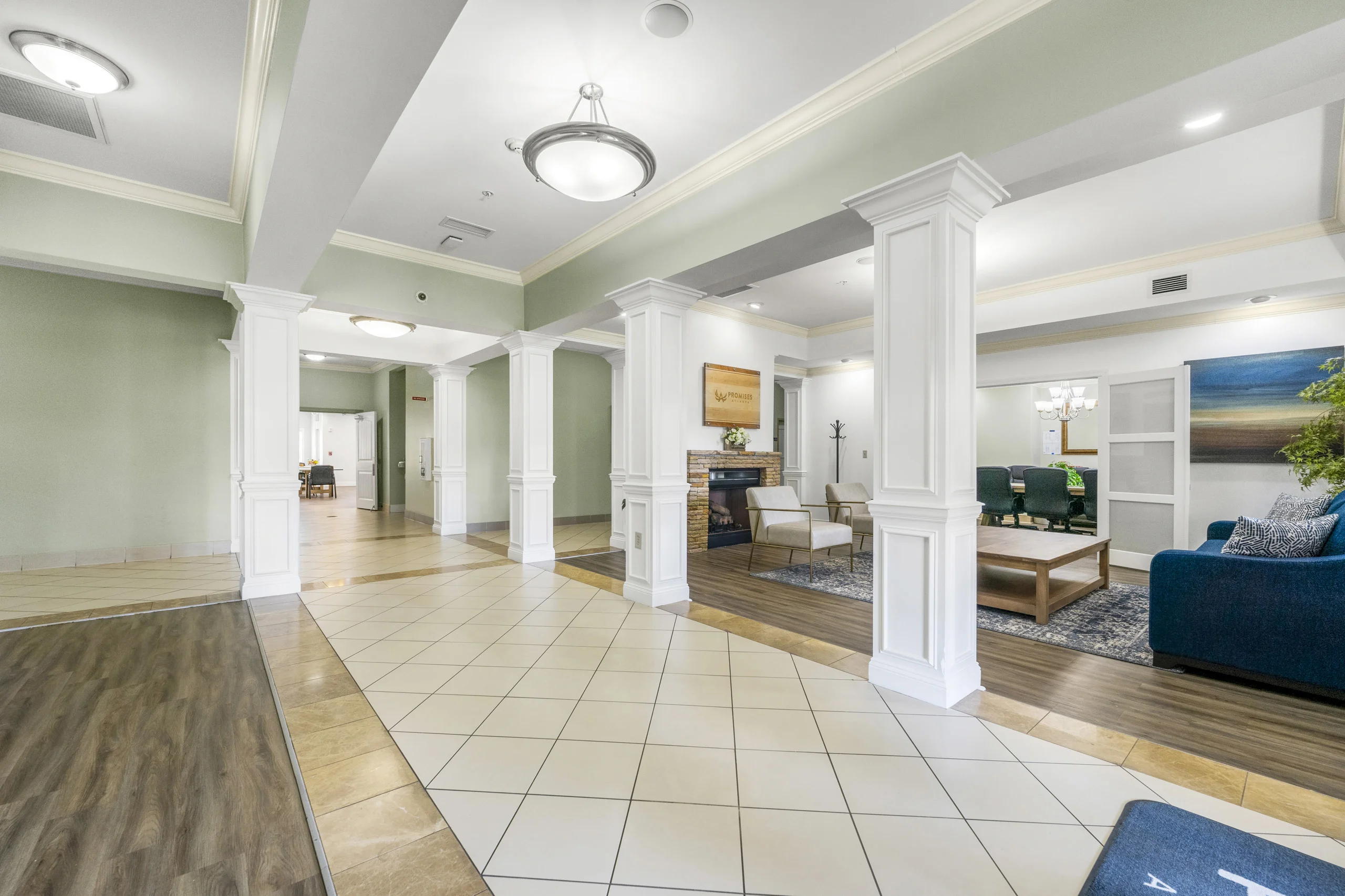 Spacious main lobby featuring elegant finishes, lounge seating, and access to meeting rooms
