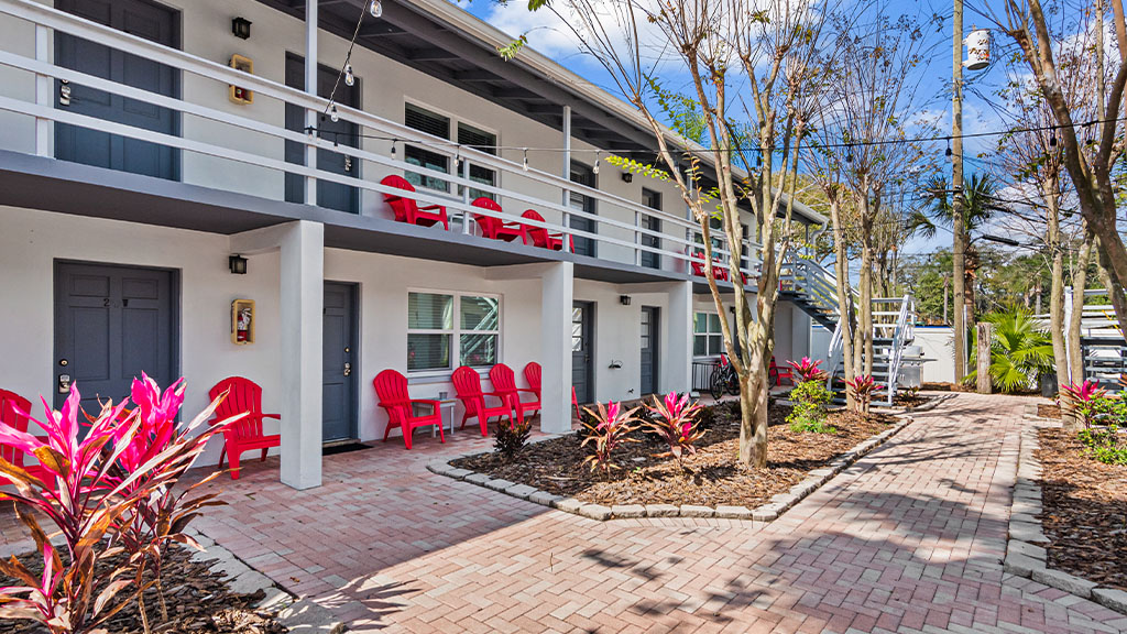 Exterior of Real Recovery Solutions Tampa with a paved walkway and trees.