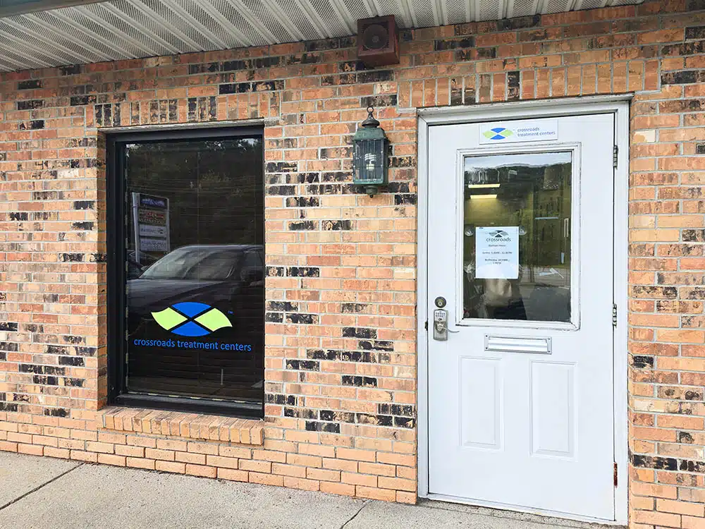 Brick exterior with window logo and front entry door