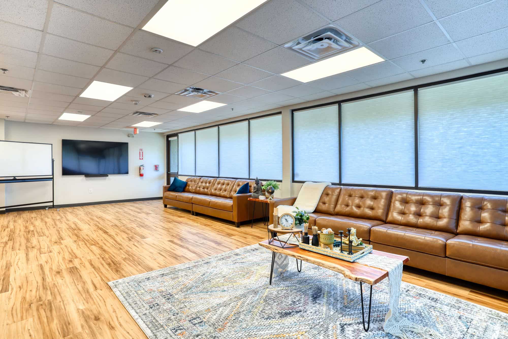 Common room with leather sofas and large TV