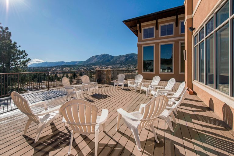 Patio with chairs overlooking mountain landscape