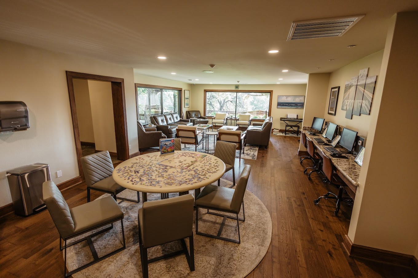 Lounge area with seating, computers, and large windows