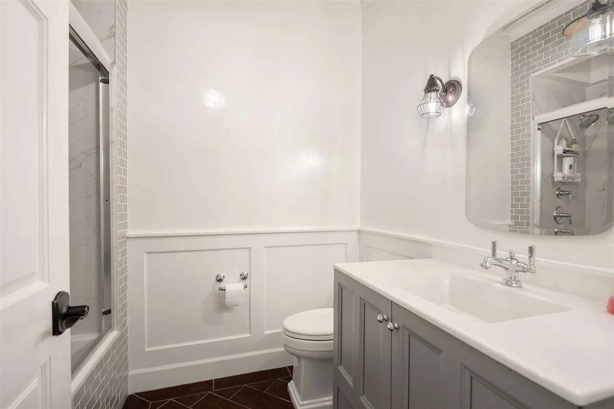Clean bathroom with modern vanity and shower.