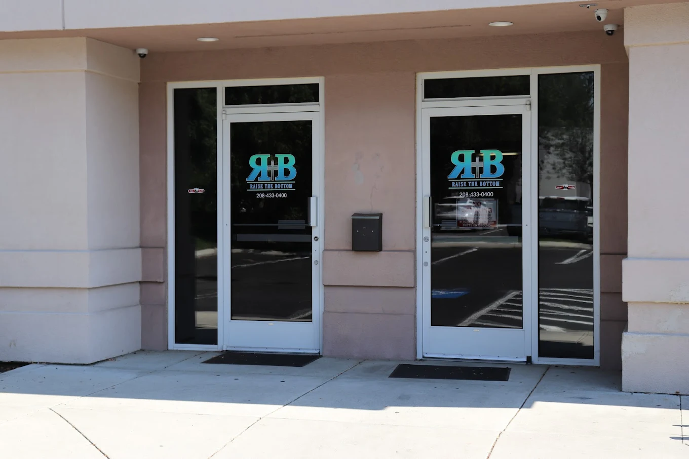 Glass entry doors with facility logo and signage