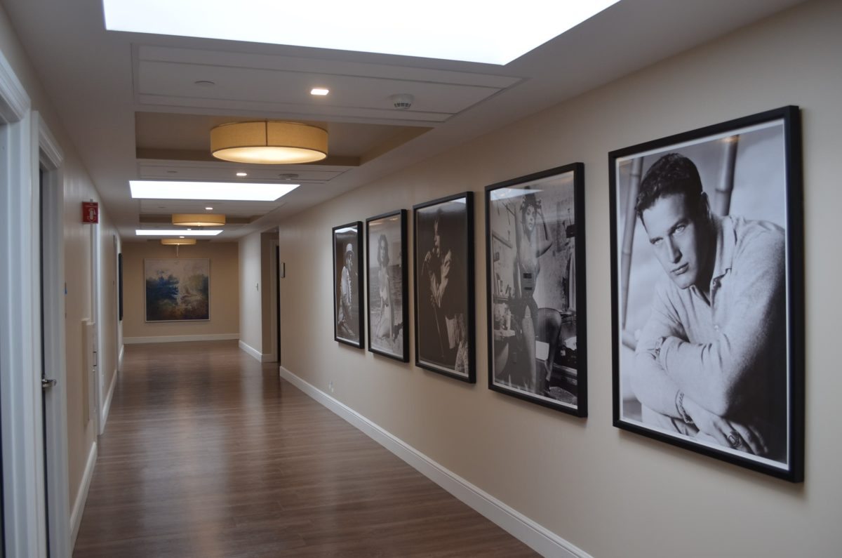 Hallway with framed black-and-white celebrity portraits.