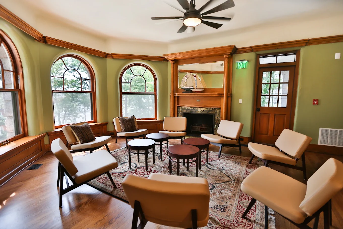 Group therapy room with chairs arranged around small tables
