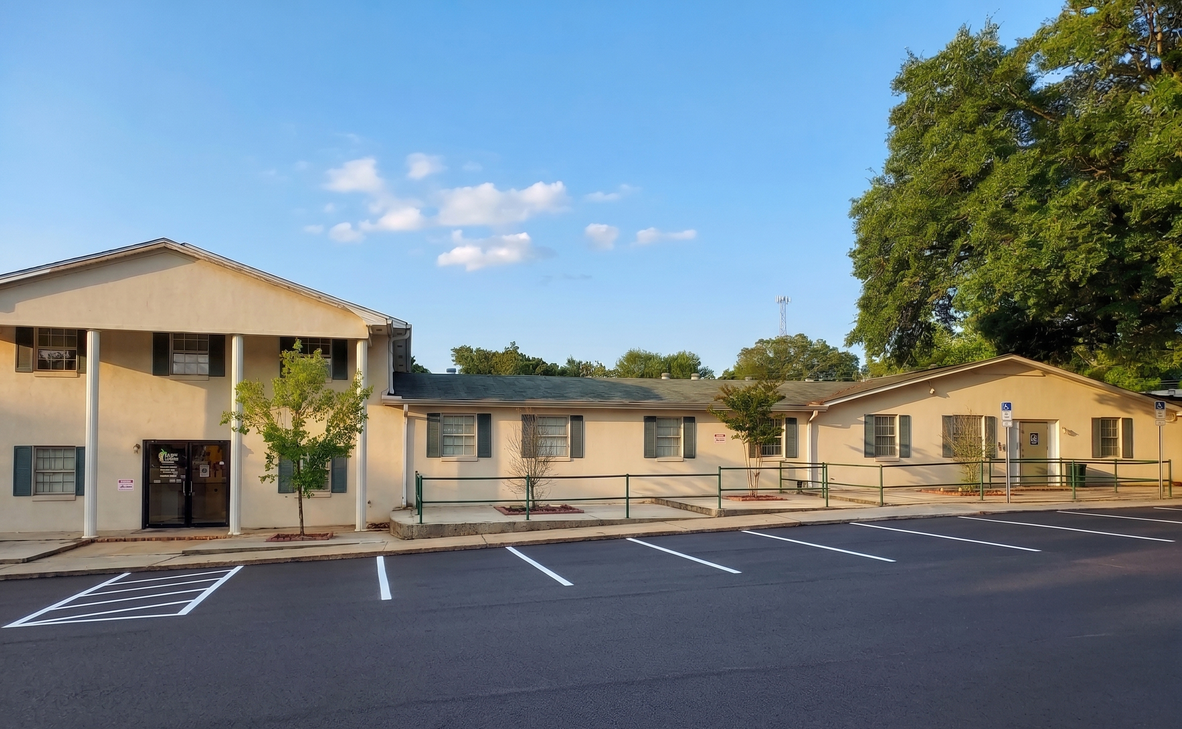 Treatment center exterior with entrance ramp and parking lot