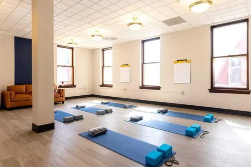 Yoga mats neatly arranged in a bright, spacious room