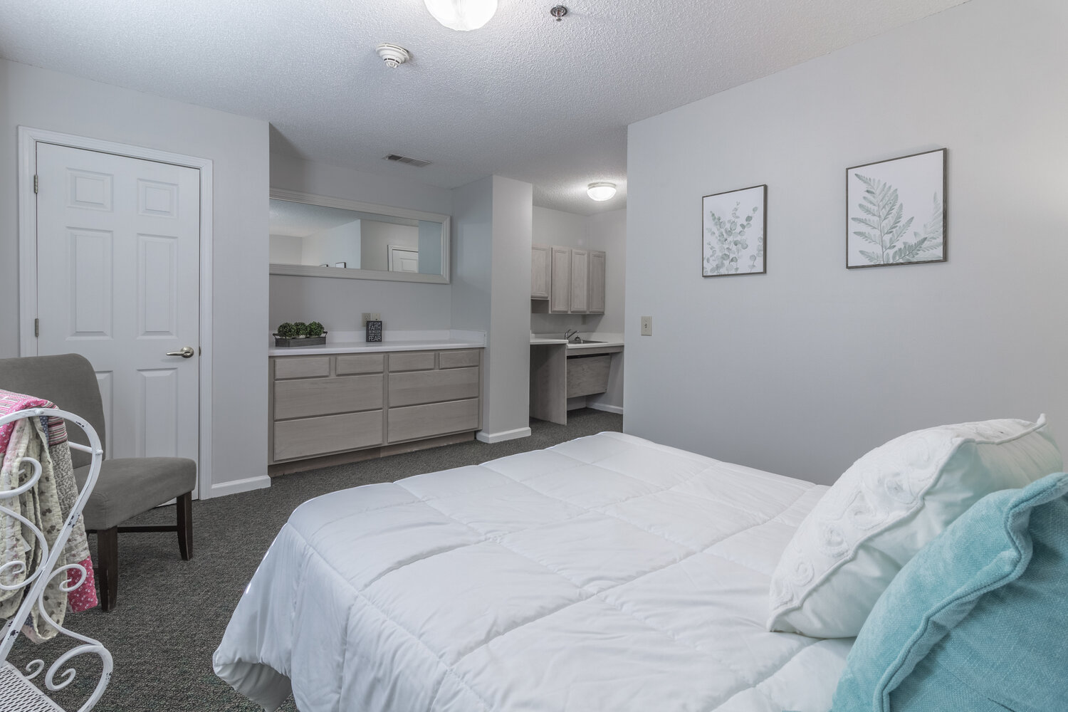 Neatly made bed in a tranquil, soft-toned room
