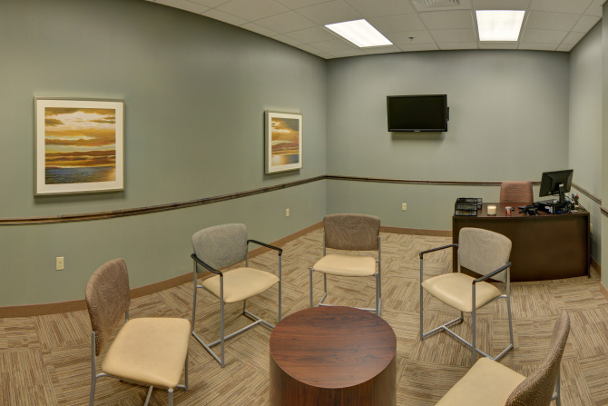 Circle of chairs and desk in small meeting room