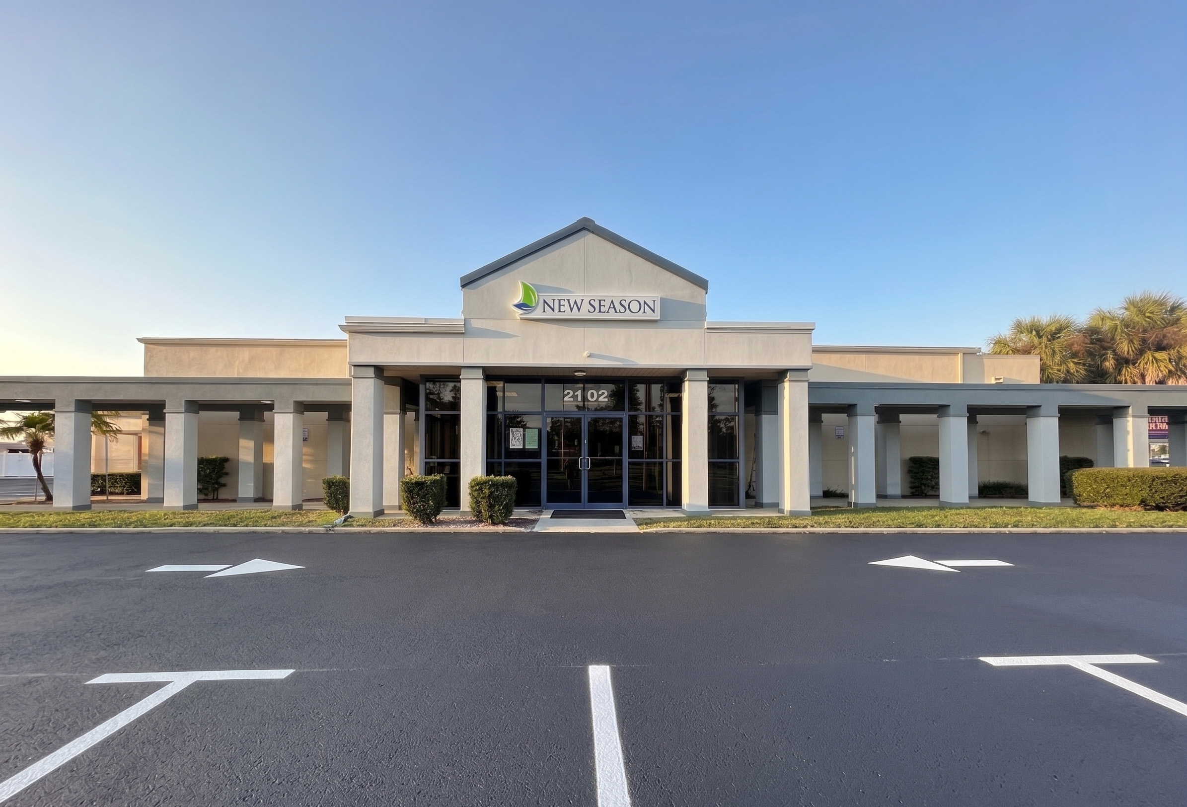 New Season facility entrance with columns and glass doors