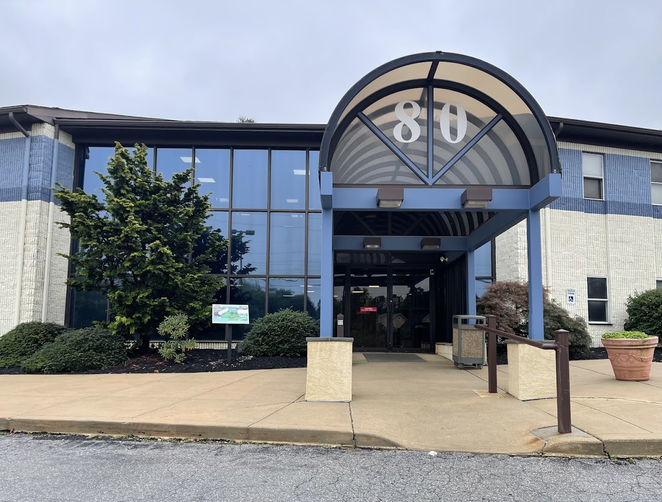 The exterior of a modern building with a glass entrance.